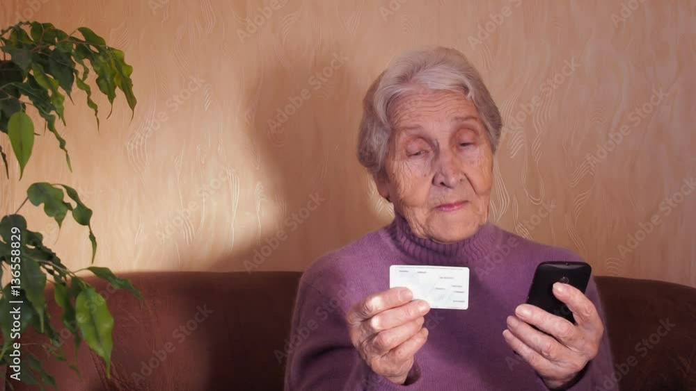 An elderly woman with a credit card. Full hd An elderly woman with a credit card. Full hd