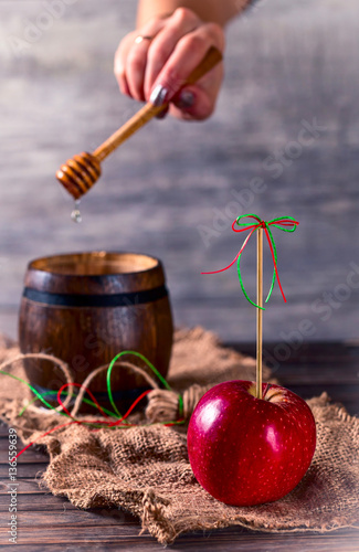 Red Apple and a barrel with honey