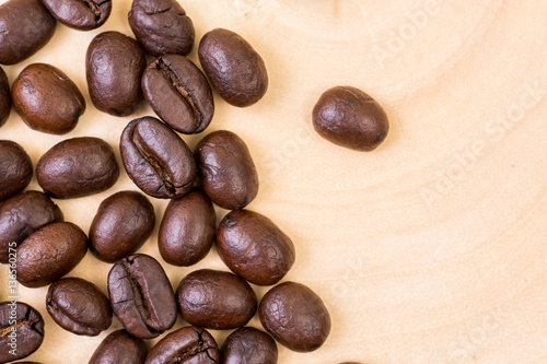 Fototapeta Naklejka Na Ścianę i Meble -  Top view of roasted coffee bean on wood texture background