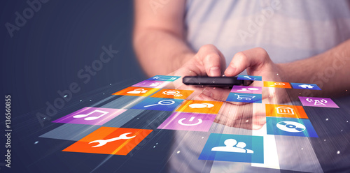 Man holding smart phone with colorful application icons