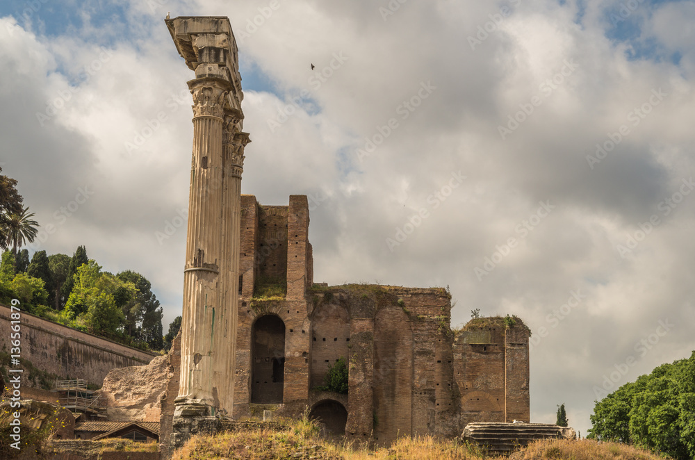 The Roman Forum is a plaza surrounded by many ruins of ancient government buildings in the center of Rome