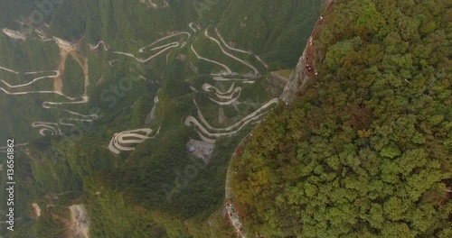 Famous glass walk top view and aerial shot of the long and windy 99 turn road going up to the summit of Tianmen shan in mountain national park, Hunan province, China.