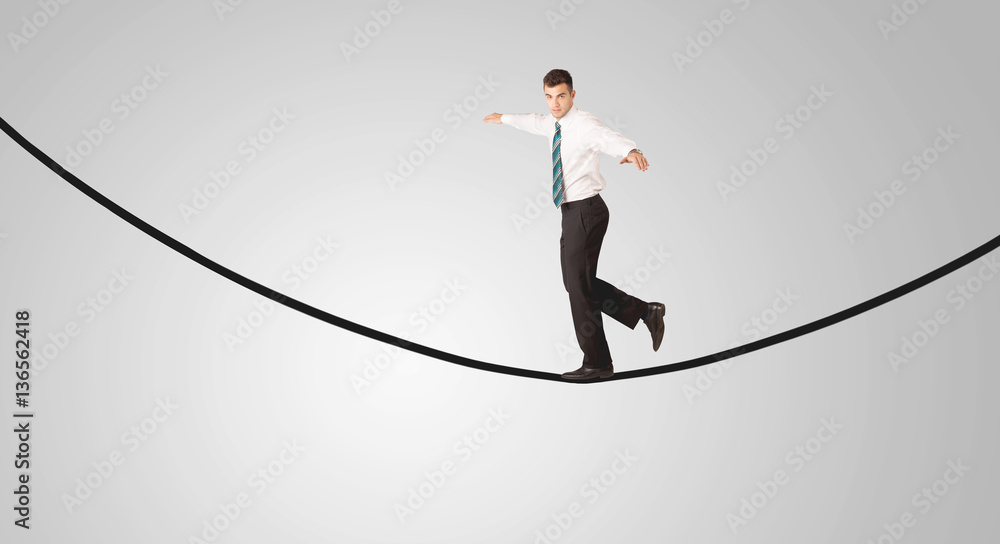 Happy businessman walking on rope Happy businessman walking on rope