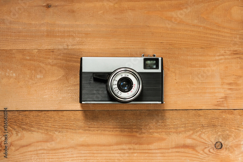 Vintage Old Retro Camera On Wooden Brown Board Top View.