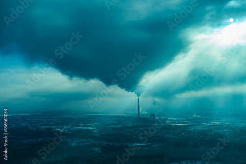 Air pollution smoke from pipes and factory with winter background