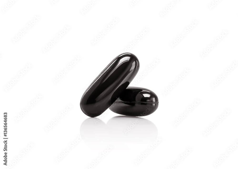 black supplement capsule isolated on white background Stock Photo ...