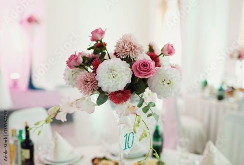 Beautiful wedding flower decoration on the table © myronovychoksana
