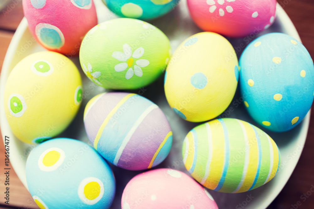 close up of colored easter eggs on plate