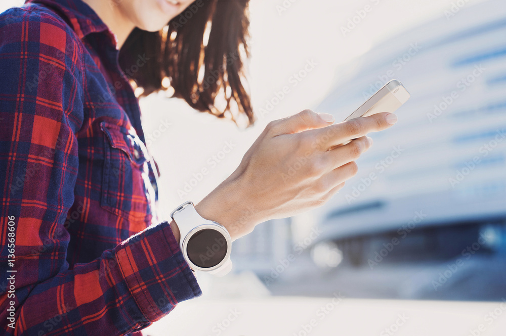 Beautiful young woman using smartphone in the city