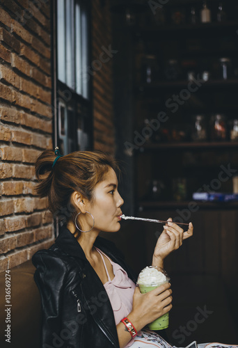 Portrait of woman smiling and drinking green tea