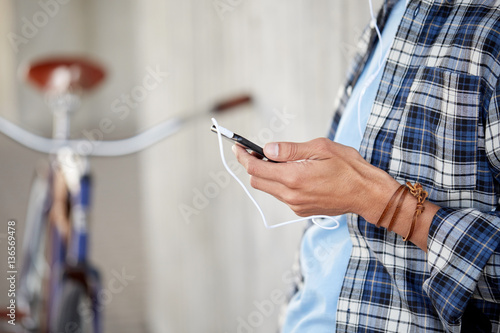 man with earphones and smartphone listening music