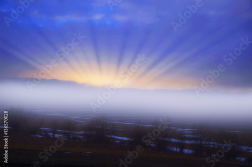 Foggy meadow morning with sunrays and mist landscape