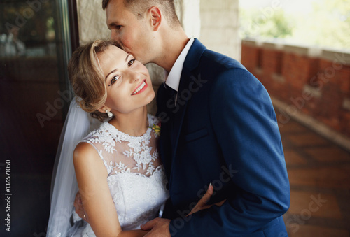 Lovely kiss of the groom to his bride