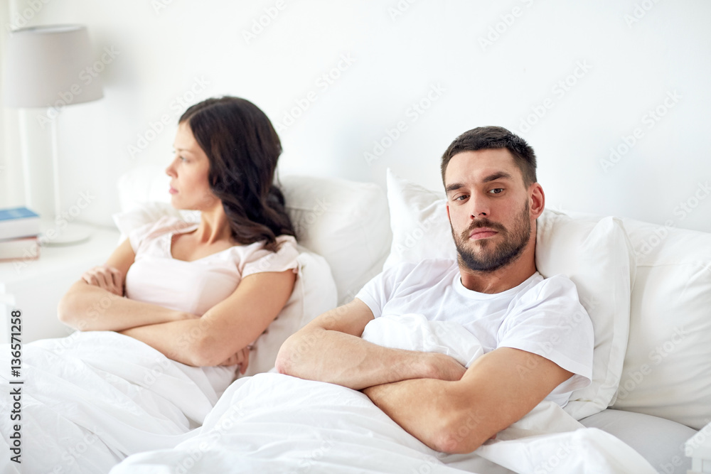 unhappy couple having conflict in bed at home unhappy couple having conflict in bed at home