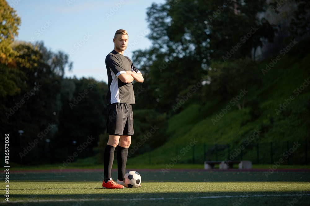 soccer player with ball on football field