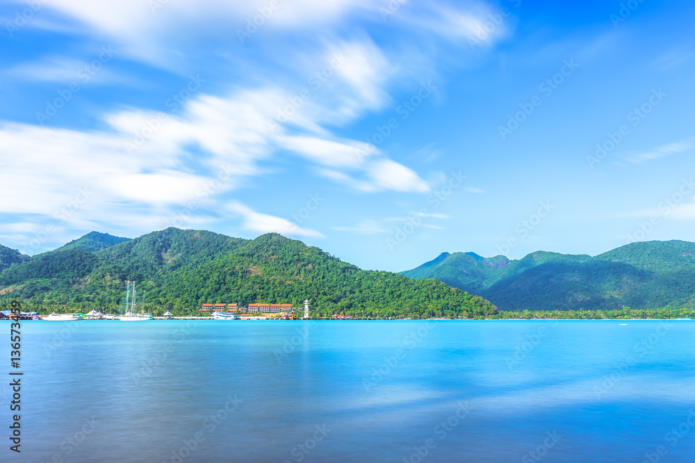 Scenic view of the harbour with mountain background against cloudy sky at Bang-Bao Koh Chang Island, (Thailand).