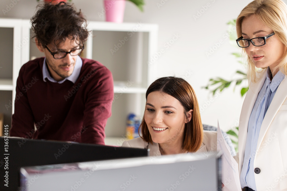 happy creative team with computer in office happy creative team with computer in office