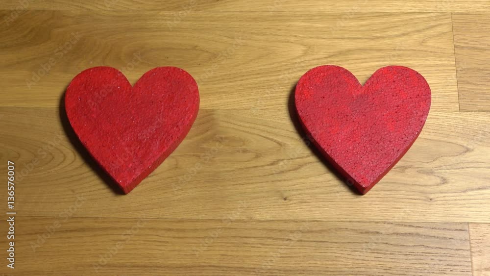 Woman hands putting two red heart shapes and lighting up a candle. Love, romance, Valentine's day, togetherness, family, date concepts. 4K video, top view Woman hands putting two red heart shapes and lighting up a candle. Love, romance, Valentine's day, togetherness, family, date concepts. 4K video, top view