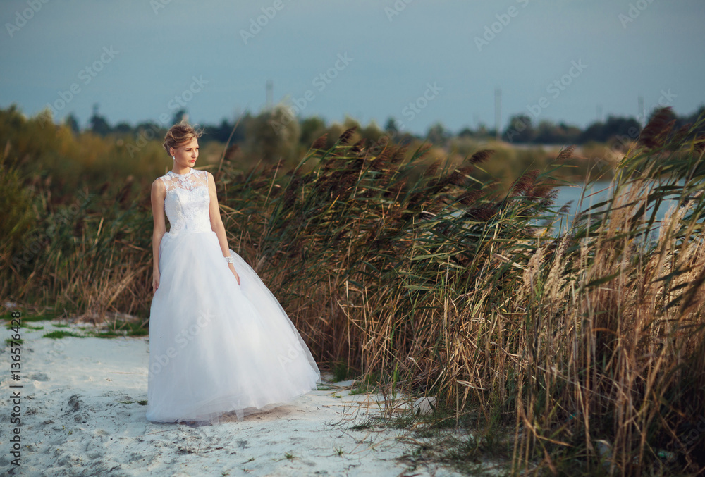 Atmospheric photo of the bride next to the lake Atmospheric photo of the bride next to the lake