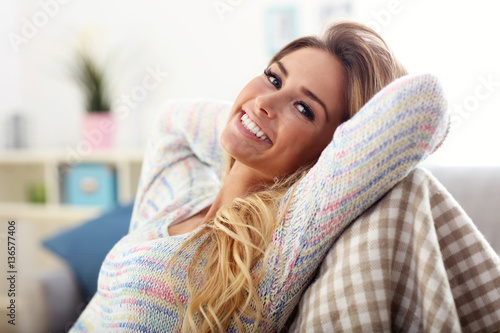 Happy woman resting on sofa