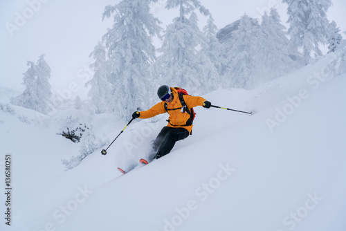 Man skiing in deep powder snow, Krippenstein, Gmunden, Austria photo