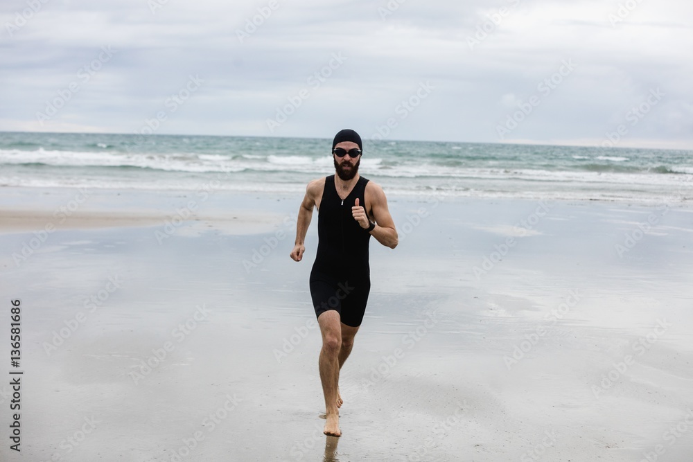 Man in swimming costume and swimming cap running Man in swimming costume and swimming cap running