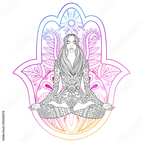 Woman sitting in lotus position on color hamsa hand background.