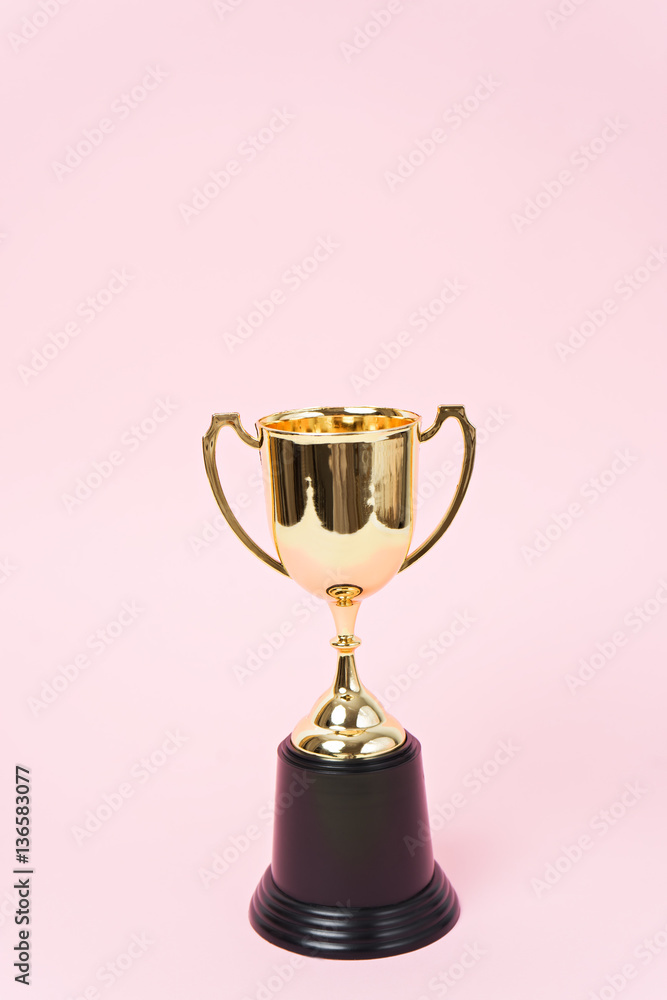 gold winner cup on pink background gold winner cup on pink background