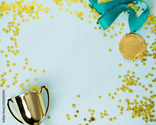 gold medal and cup on blue background photo