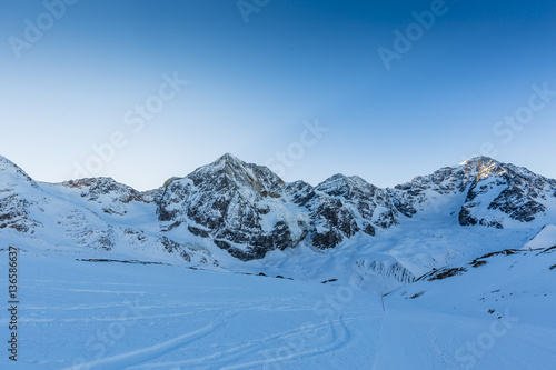 Ski winter season, ski run in Italian Alps. Solda with Ortler, Zebru, Grand Zebru in background. Val Venosta, South Tirol, Italy. 