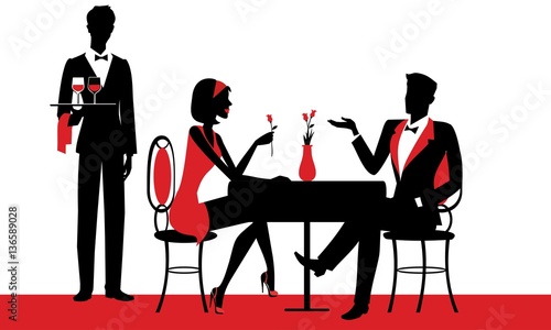 Couple sitting at the restaurant - the chef waiter with drinks in his hand - silhouettes