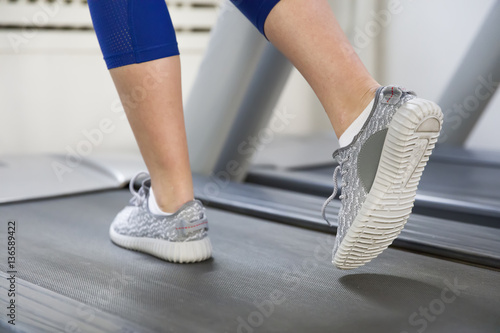 Fitness girl running on treadmill