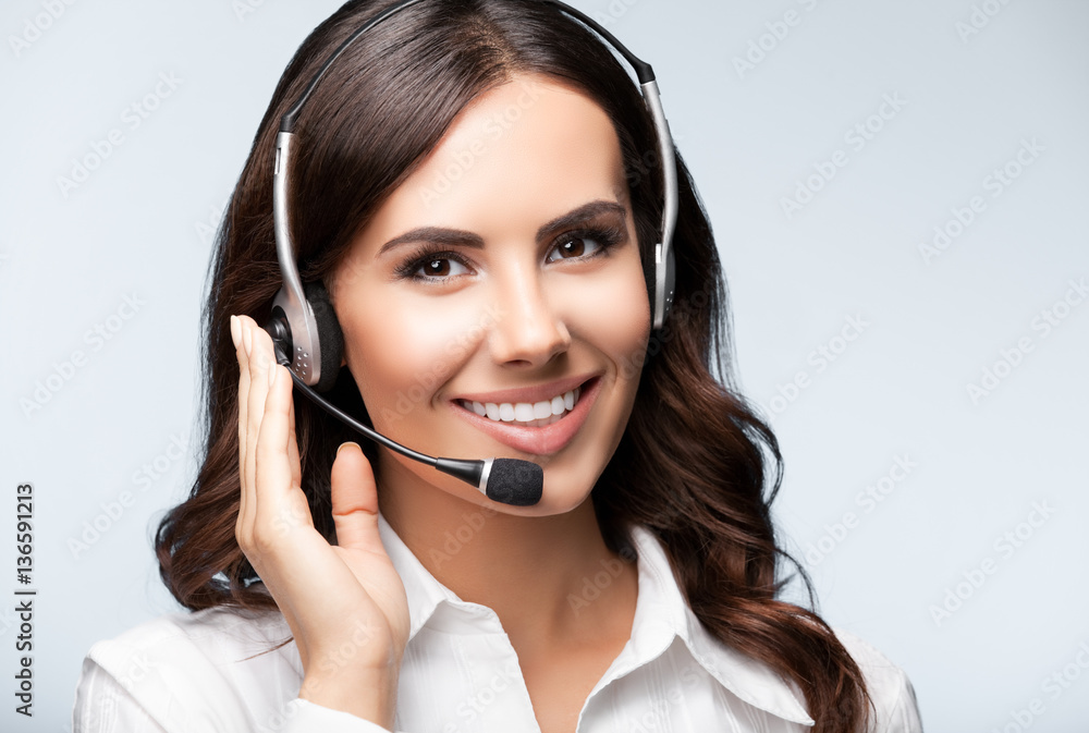 Portrait of happy smiling customer support female phone operator Portrait of happy smiling customer support female phone operator