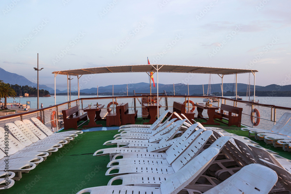 Sunbeds on the ship under the open sky, a lot of plastic beds fo