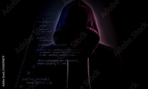 Фотография Hooded hacker in dark with code