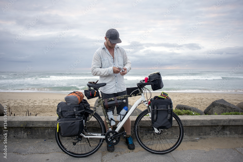 Fototapeta premium Long Distance Cyclist with Bicycle by Ocean