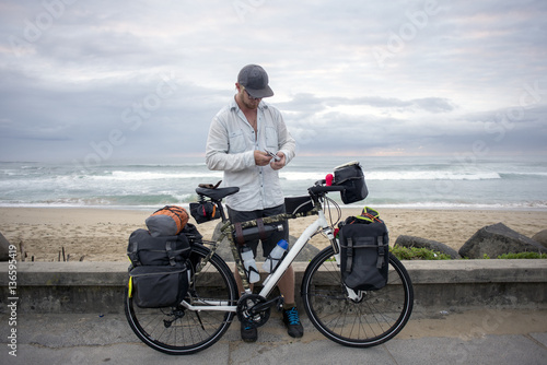 Long Distance Cyclist with Bicycle by Ocean