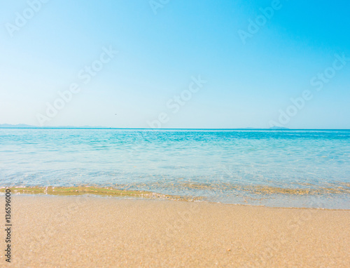 Beach and tropical sea soft wave of blue clear sky ocean on sandy. Seascape Background