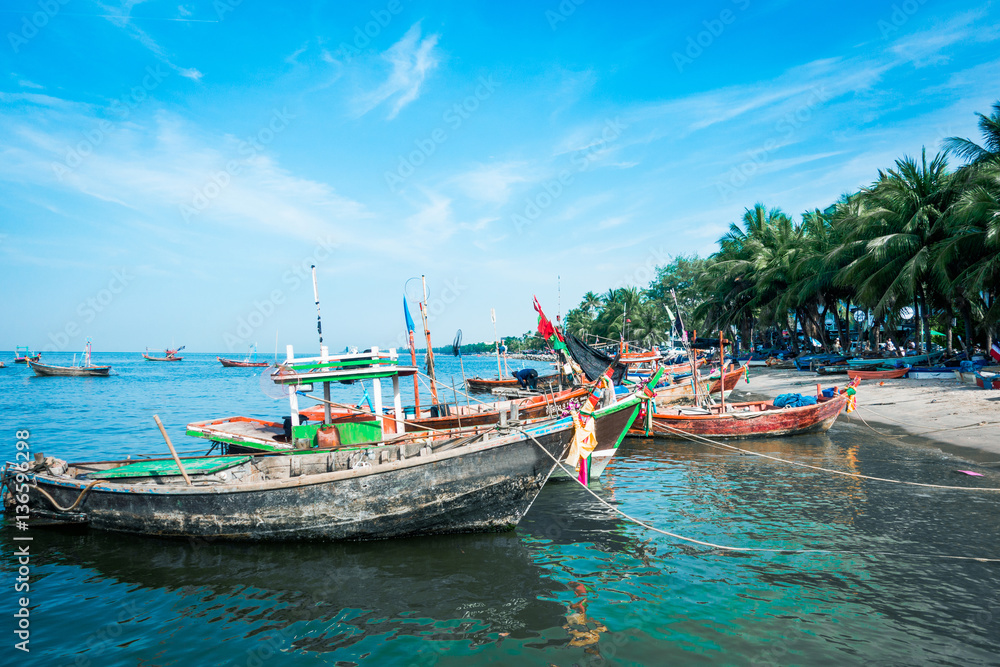 Historic wooden fishing boats in sandy beach and Blue sky with clouds background