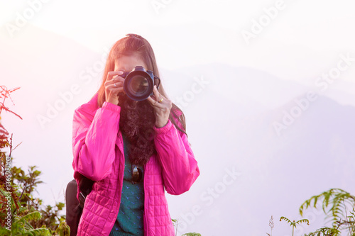 asian traveller shoot landscape on hill background