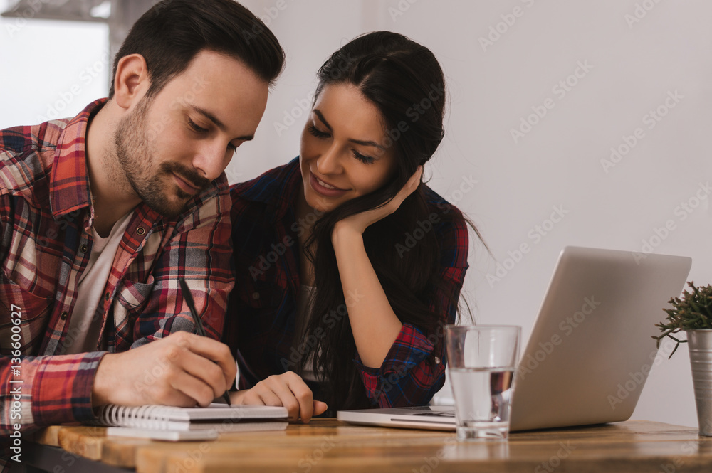 Beautiful young woman and man working from home, modern business Beautiful young woman and man working from home, modern business