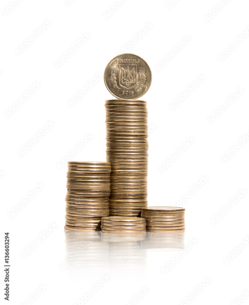 Several piles of coins with ukrainian coin on top Several piles of coins with ukrainian coin on top