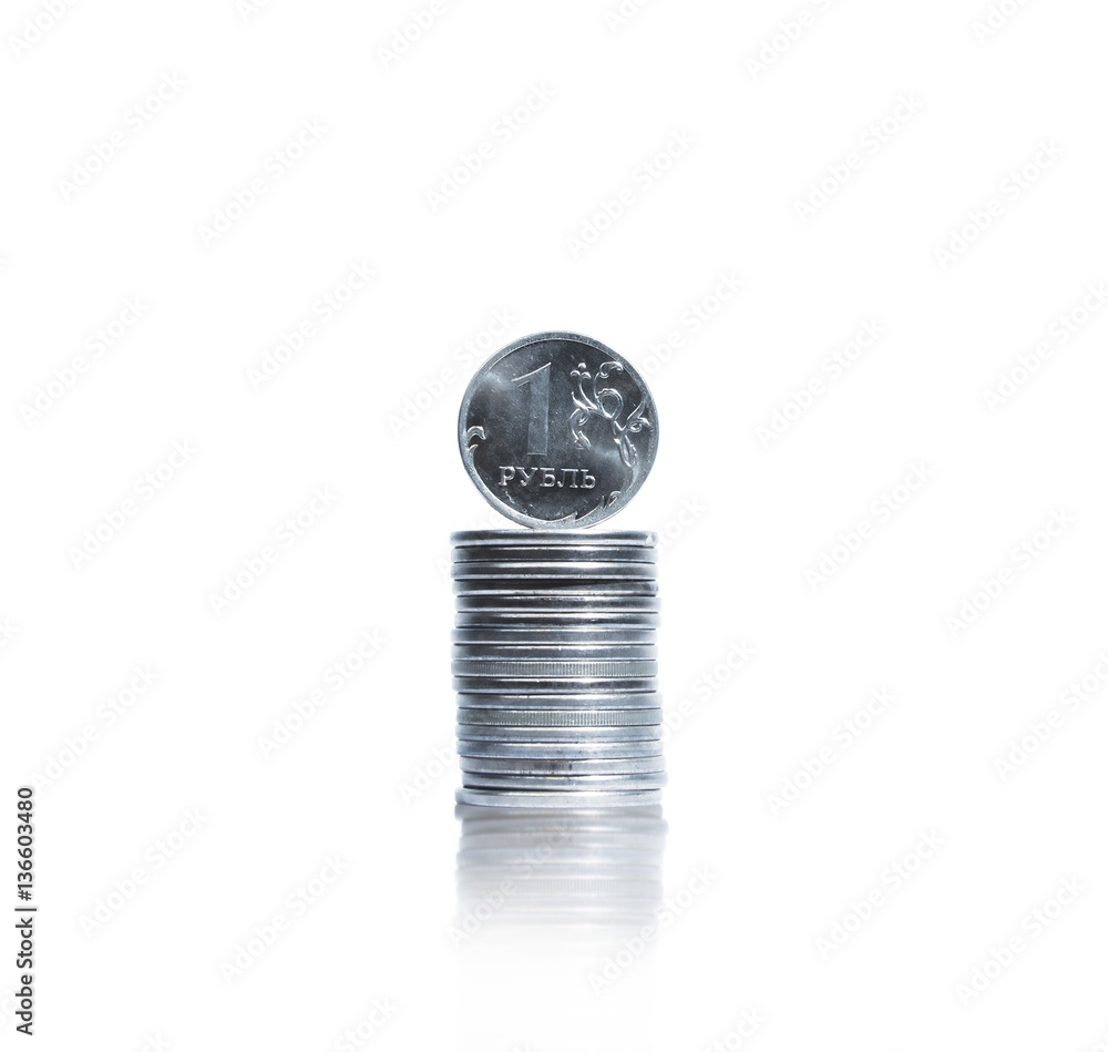 Stack of coins with one russian ruble on top Stack of coins with one russian ruble on top