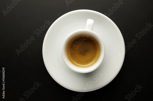A cup of fragrant coffee on a black background.