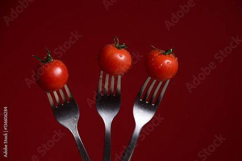 close-up of pasta and fresh tomatoes on forks