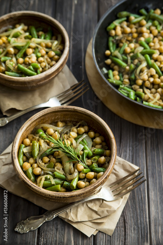 chickpea stew with green beans and onion, seasoned with rosemary. vegan food
