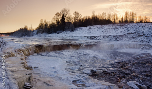 Winter waterfall. Winter landscape with a waterfall at sunset. Sablinsky waterfall. Russia Leningrad region