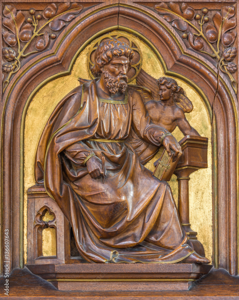 VIENNA, AUSTRIA - DECEMBER 19, 2016: The carved relief of St. Matthew the Evangelist in church Brigitta Kirche by unknown artist of 19. cent.