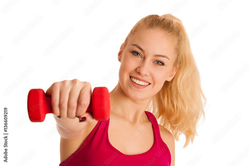 Cute young blond woman working out in fitness gym isolated over Cute young blond woman working out in fitness gym isolated over