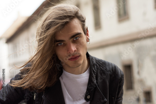 Attractive Young Man With Long Hair and Blue Eyes.